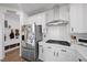 Stylish kitchen with stainless steel appliances, white cabinets, and modern lighting at 11826 Corenzio Ave, Las Vegas, NV 89138