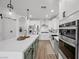 Well-appointed kitchen features stainless steel appliances, white cabinets, and a large center island at 11826 Corenzio Ave, Las Vegas, NV 89138