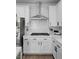 Modern kitchen with white cabinetry, stainless steel appliances, and subway tile backsplash at 11826 Corenzio Ave, Las Vegas, NV 89138