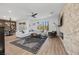 Spacious living room features modern decor, a cozy fireplace, and ample natural light from large windows at 11826 Corenzio Ave, Las Vegas, NV 89138