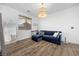 Upstairs living room featuring wood-look floors and a comfortable blue sofa at 11826 Corenzio Ave, Las Vegas, NV 89138