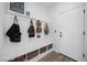 Functional mud room with built-in bench, storage baskets, and coat hooks at 11826 Corenzio Ave, Las Vegas, NV 89138