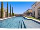 Private pool and spa surrounded by well-maintained landscaping and tall privacy trees at 11826 Corenzio Ave, Las Vegas, NV 89138