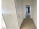 Hallway view leads to kitchen with white appliances and tile flooring throughout at 1308 Harriet St, Las Vegas, NV 89101