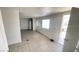 Open concept living area features tile flooring and view of front door at 1308 Harriet St, Las Vegas, NV 89101