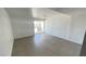 Large living area features sliding glass door and tile flooring throughout the space at 1308 Harriet St, Las Vegas, NV 89101