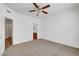 Spacious carpeted bedroom with a ceiling fan, includes a door to the ensuite bathroom at 1840 N Jones Blvd, Las Vegas, NV 89108