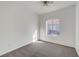 Bright bedroom with neutral carpet, ceiling fan, and window providing natural light at 1840 N Jones Blvd, Las Vegas, NV 89108