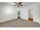 Bedroom with a ceiling fan and neutral carpet featuring doorways to the laundry and bathroom at 1840 N Jones Blvd, Las Vegas, NV 89108