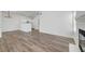 Spacious living room with wood-look flooring, light-colored walls, and an open concept layout flowing into the kitchen at 1840 N Jones Blvd, Las Vegas, NV 89108