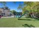 A backyard with a playground area, refreshing pool, and ample seating for relaxation and entertainment at 1853 Heydon Ct, Henderson, NV 89014