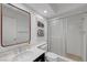 Bathroom with a framed mirror, marble countertop, and enclosed shower at 1853 Heydon Ct, Henderson, NV 89014