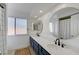 Bright bathroom featuring double sinks, round mirrors, modern fixtures, and ample natural light at 1853 Heydon Ct, Henderson, NV 89014