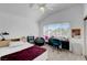 Bedroom features a bed, desk, vanity, large windows, and a ceiling fan at 1853 Heydon Ct, Henderson, NV 89014