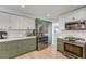 Modern kitchen with stainless steel appliances and two-tone cabinetry at 1853 Heydon Ct, Henderson, NV 89014