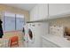 Well-organized laundry room with front-load washer and dryer, ample storage, and bright natural light at 1853 Heydon Ct, Henderson, NV 89014