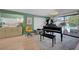 Comfortable sitting area with grand piano and outdoor view at 1853 Heydon Ct, Henderson, NV 89014