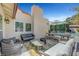 Cozy outdoor patio with comfortable seating, shade umbrella, and pool view at 1853 Heydon Ct, Henderson, NV 89014