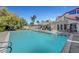 Large backyard pool with attached spa, poolside seating and views of the property's exterior at 1853 Heydon Ct, Henderson, NV 89014
