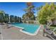 Relaxing backyard pool featuring lush landscaping, poolside lounge chairs, and a serene atmosphere at 1853 Heydon Ct, Henderson, NV 89014