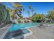 Backyard pool area with lounge chairs, lush landscaping, and a relaxing spa at 1853 Heydon Ct, Henderson, NV 89014