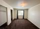 Bedroom with carpeting, window with blue curtains and two closets at 1964 Las Palmas Ln # 244, Laughlin, NV 89029
