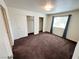 Bedroom featuring a large window with natural light and spacious closets with brown carpet at 1964 Las Palmas Ln # 244, Laughlin, NV 89029