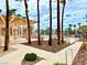 Exterior view of community, with palm trees, condos, pool, walkways, landscaping, and shade pergola at 1964 Las Palmas Ln # 244, Laughlin, NV 89029