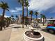 Exterior view of a condo community featuring palm trees, a water fountain, and well-maintained walkways at 1964 Las Palmas Ln # 244, Laughlin, NV 89029
