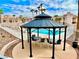 Seating area with table and chairs under gazebo near the community pool and condos at 1964 Las Palmas Ln # 244, Laughlin, NV 89029