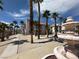 Exterior view of a condo community with palm trees, a water fountain, and well-maintained walkways at 1964 Las Palmas Ln # 244, Laughlin, NV 89029