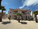 Two-story building featuring balconies and patios with desert landscaping and palm trees at 1964 Las Palmas Ln # 244, Laughlin, NV 89029