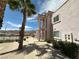 Two-story condo building with exterior stairs, a small balcony, and desert landscaping on a sunny day at 1964 Las Palmas Ln # 244, Laughlin, NV 89029