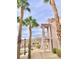 Building exterior with palm trees, sidewalks, and lovely mountain views on a sunny day at 1964 Las Palmas Ln # 244, Laughlin, NV 89029