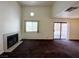 Bright living room with a tiled fireplace, large window, and sliding door to balcony at 1964 Las Palmas Ln # 244, Laughlin, NV 89029