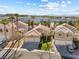 Aerial view of single-story homes with desert landscaping and tile roofs at 2163 Fountain Springs Dr, Henderson, NV 89074