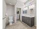 Accessible bathroom with double sink vanity, grab bars, and walk-in closet at 2163 Fountain Springs Dr, Henderson, NV 89074
