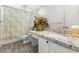 Bathroom with granite counter tops, decorative floral shower curtain and a matching flower arrangement at 2163 Fountain Springs Dr, Henderson, NV 89074