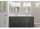 Stylish bathroom features a double vanity with gray cabinets and and square mirrors at 2163 Fountain Springs Dr, Henderson, NV 89074