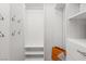 Walk-in closet boasts white shelving, rods and ample storage for hanging clothes and accessories at 2163 Fountain Springs Dr, Henderson, NV 89074