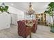 Bright dining room featuring a decorative chandelier, stylish chairs, and eye-catching display cabinet at 2163 Fountain Springs Dr, Henderson, NV 89074