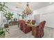 An elegant dining room showcases a stunning chandelier and a view of window shutters at 2163 Fountain Springs Dr, Henderson, NV 89074