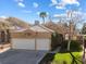 Beautiful single-story home featuring a two-car garage and desert landscaping at 2163 Fountain Springs Dr, Henderson, NV 89074
