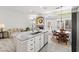 Stylish kitchen island with seating area and adjacent living room with fireplace at 2163 Fountain Springs Dr, Henderson, NV 89074