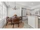 Bright eat-in kitchen with round table, modern lighting, and white cabinets at 2163 Fountain Springs Dr, Henderson, NV 89074