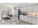 Open concept kitchen with white cabinets, granite counters, and modern appliances at 2163 Fountain Springs Dr, Henderson, NV 89074