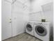 Laundry room featuring a modern washer and dryer units and overhead storage space at 2163 Fountain Springs Dr, Henderson, NV 89074