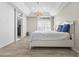 Light and airy main bedroom with tray ceilings, chandelier, and bright windows at 2163 Fountain Springs Dr, Henderson, NV 89074