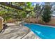 Inviting backyard with a sparkling pool, spa, and lush landscaping, perfect for outdoor relaxation and entertaining guests at 2163 Fountain Springs Dr, Henderson, NV 89074