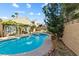 Beautiful pool and spa area surrounded by mature trees, lush greenery, and a pergola for outdoor relaxation at 2163 Fountain Springs Dr, Henderson, NV 89074